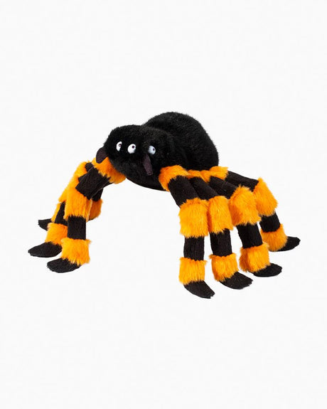 Soft plush spider with black and orange striped legs and four shiny eyes, perfect for Halloween cuddles.