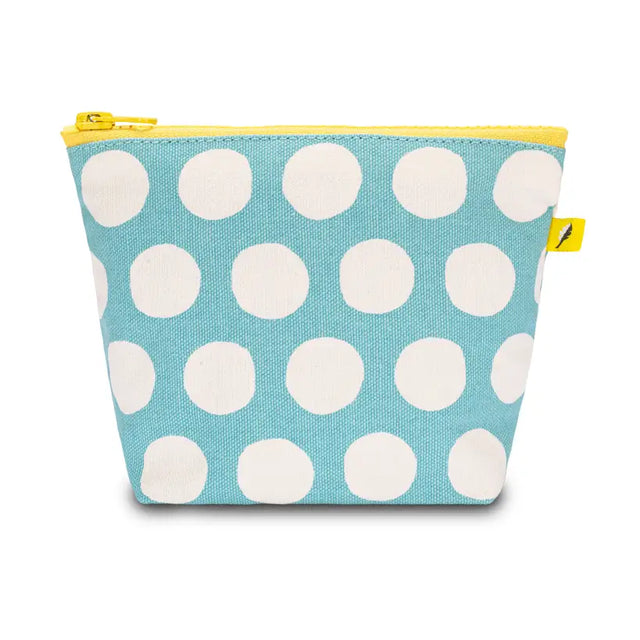 Small blue pouch with large white dots and yellow zipper, made from organic cotton and recycled materials.