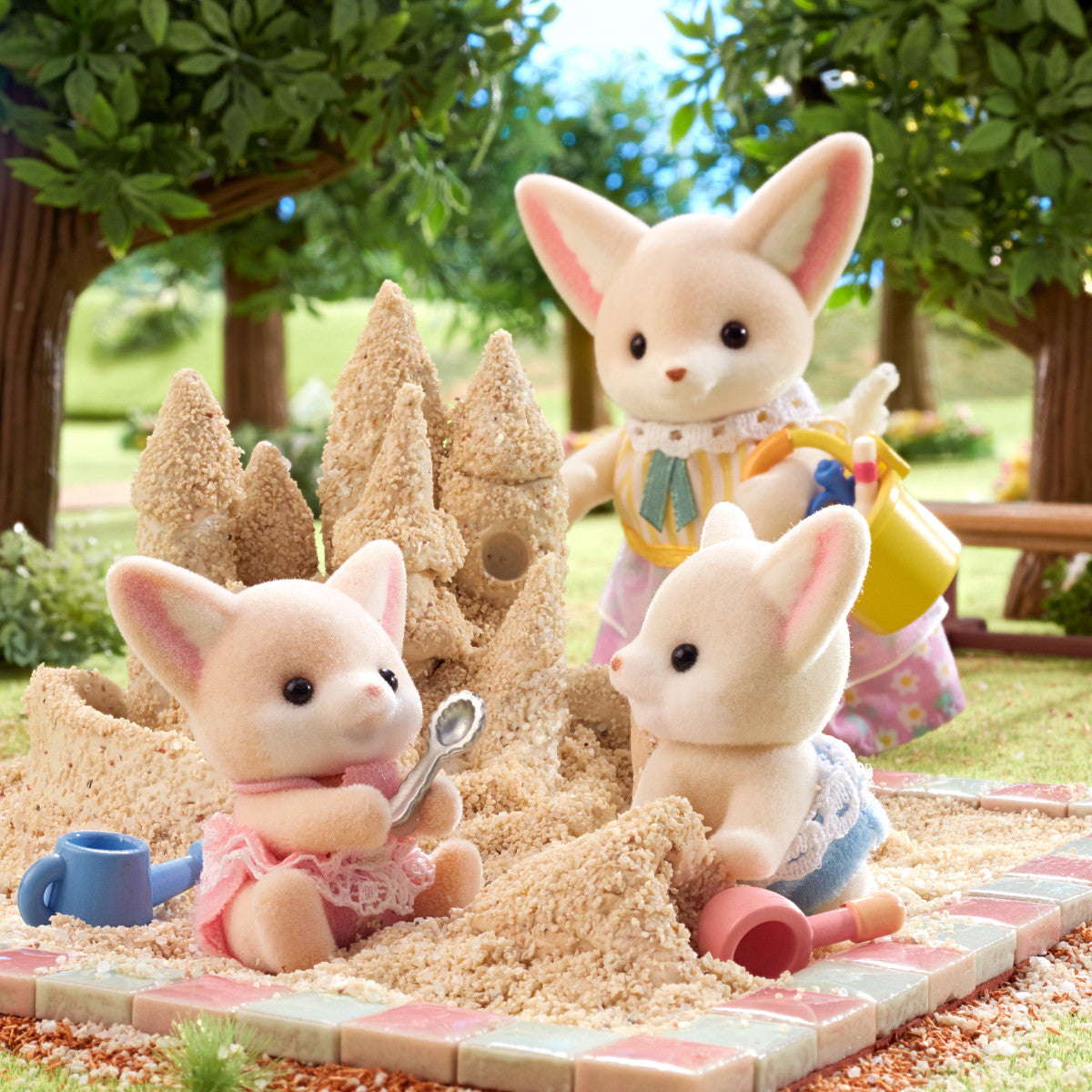 Fennec Fox Twins playing in sand with detailed clothing and miniature beach toys in a charming outdoor setting.