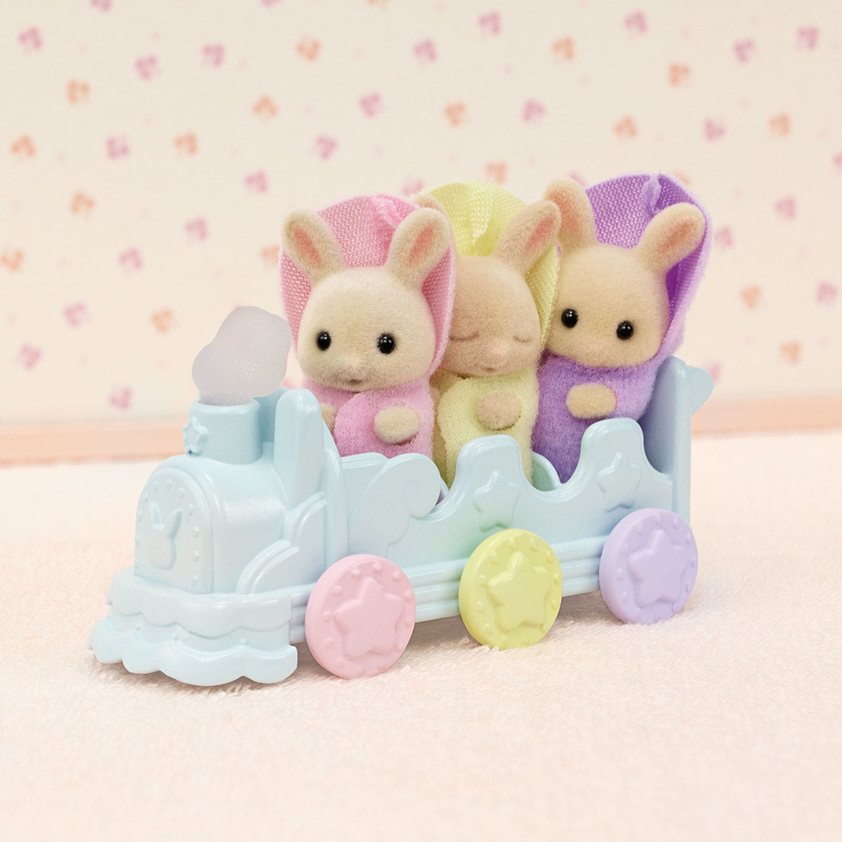 Triplets Bathtime Set with three Milk Rabbit triplets riding a pastel-colored toy pushcart for bath fun