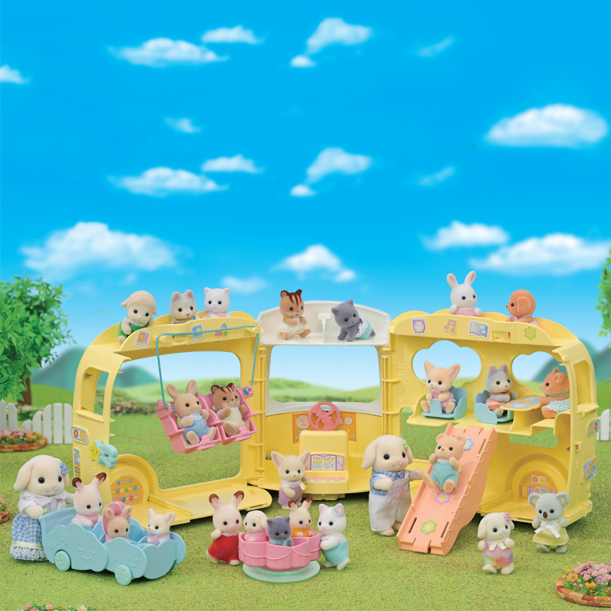 Colorful triple-decker nursery bus toy with animal figures playing, swinging, and enjoying a sunny outdoor scene.