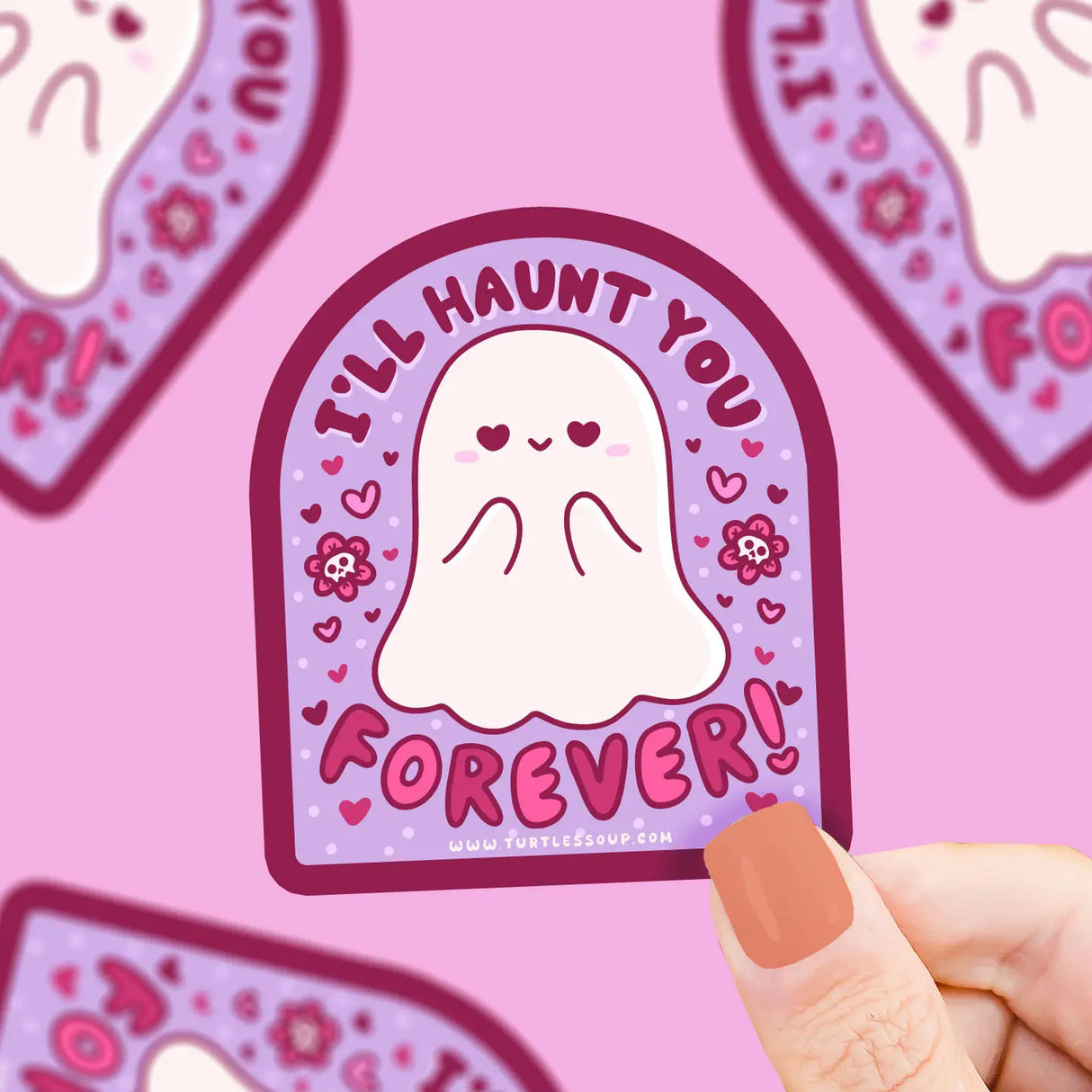A hand holding an "I'll Haunt You Forever Sticker" featuring a cute ghost on a purple background.