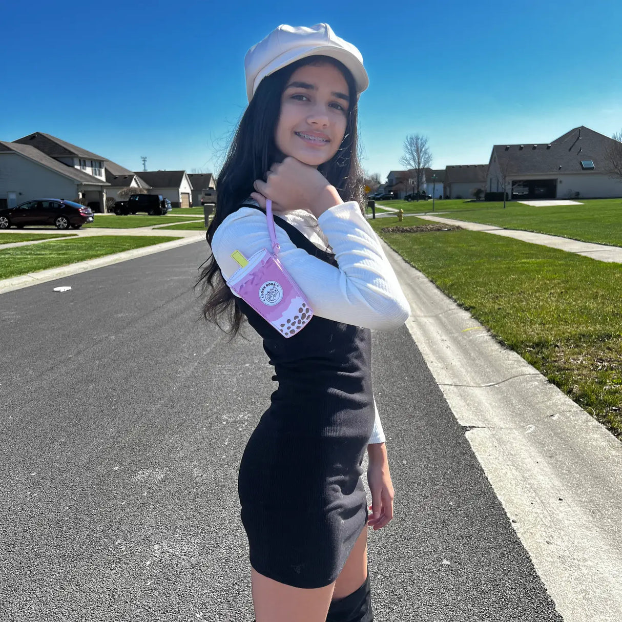 Young woman outdoors holding Wristlet | Taro Boba Milk Tea purse with pink PU leather strap and card slot.