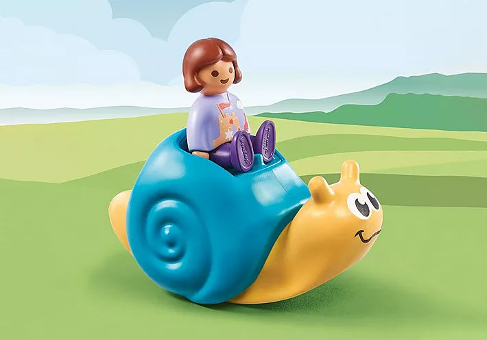 123 Rocking Snail toy with rattle feature and figure, perfect for developing fine motor skills in toddlers.