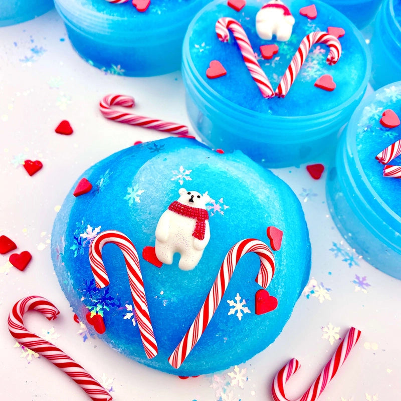Arctic Icee Cola Soda Jelly Slime with icy blue texture, polar bear charm, candy canes, and red heart decorations.