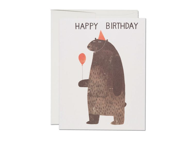 Birthday card featuring a standing bear wearing a party hat and holding a balloon with Happy Birthday text above.
