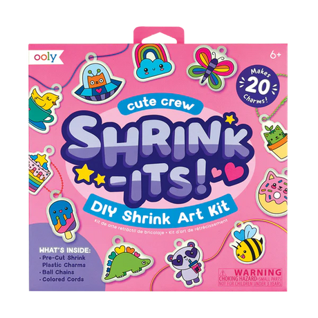 Shrink-Its! Cute Crew DIY Shrink Art Kit with 20 pre-cut charms, ball chains, and colorful cords in a pink box.