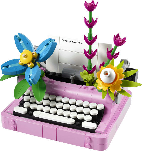 Creator Typewriter with Flowers LEGO set featuring a pink typewriter adorned with colorful brick-built flowers and paper.