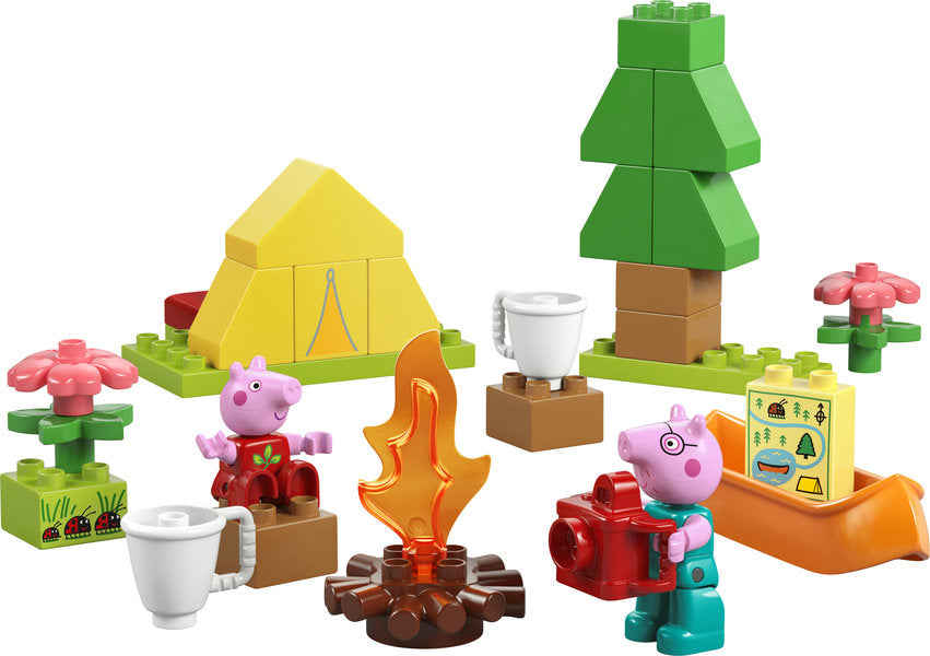 Duplo Peppa Pig Camping Trip playset with tent, campfire, tree, flowers, Peppa and Daddy Pig figures, and camping accessories.