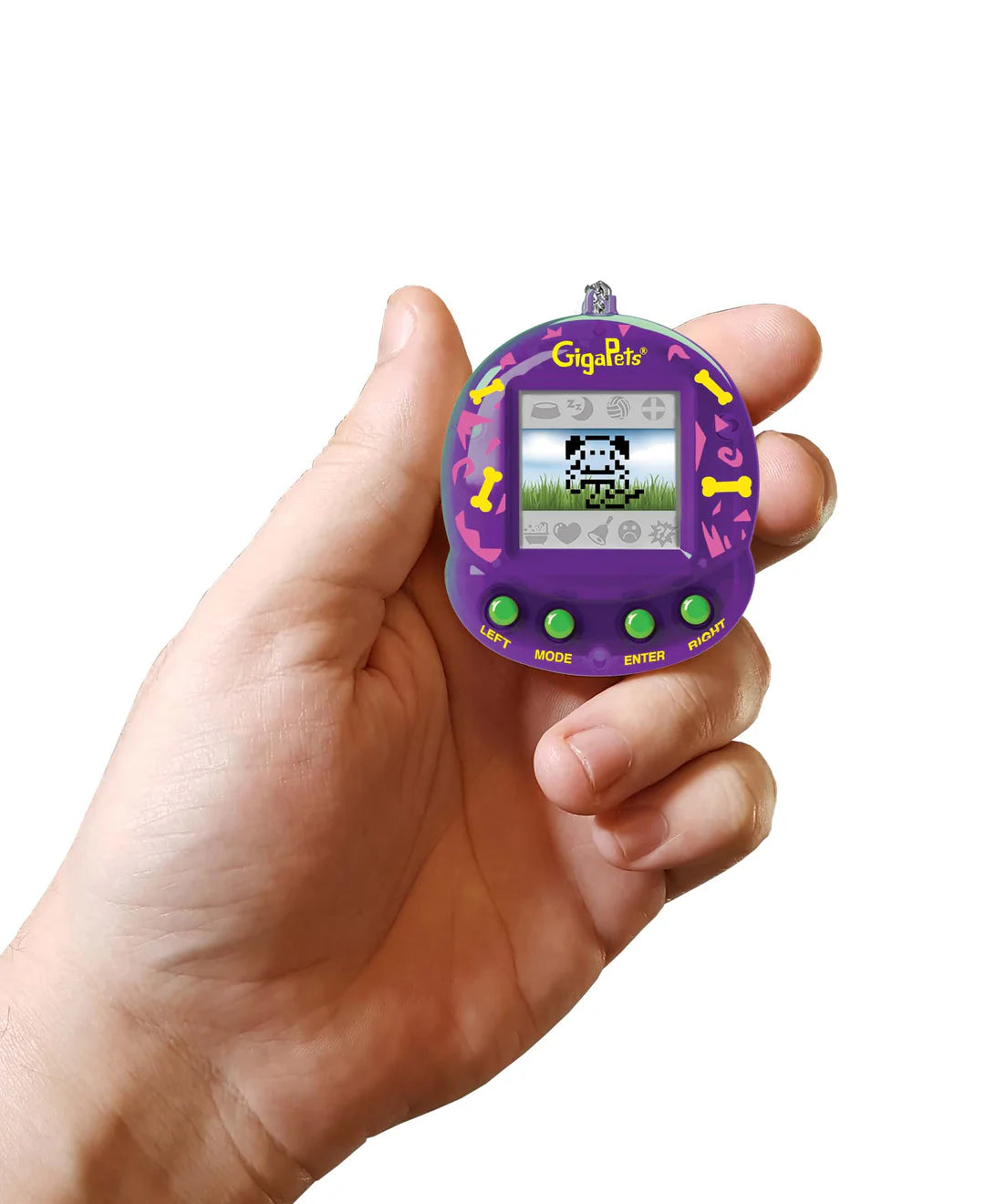 Hand holding a purple GigaPets Pixel Puppy virtual pet toy with pixelated puppy on screen and control buttons.