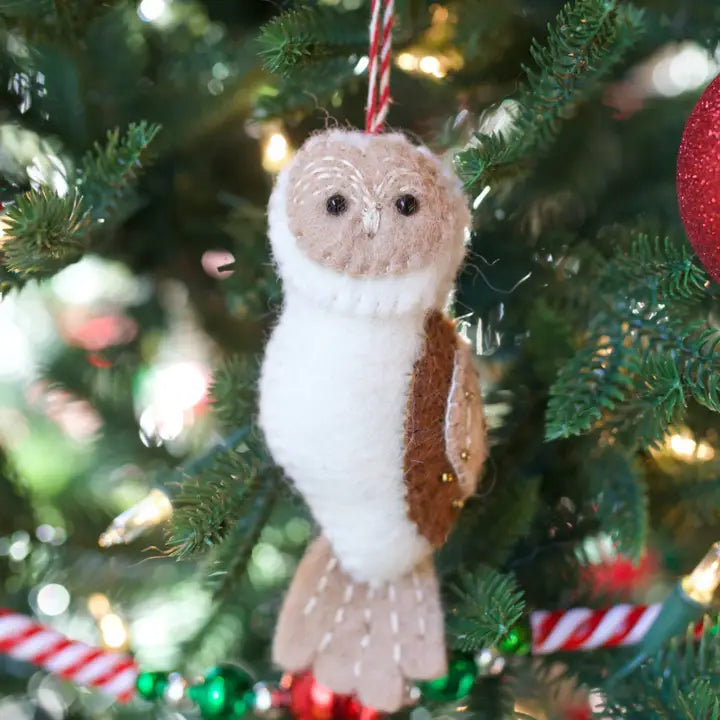 Owl Felt Ornament hanging on Christmas tree, handcrafted wool with beaded eyes and gold bead details on wings.