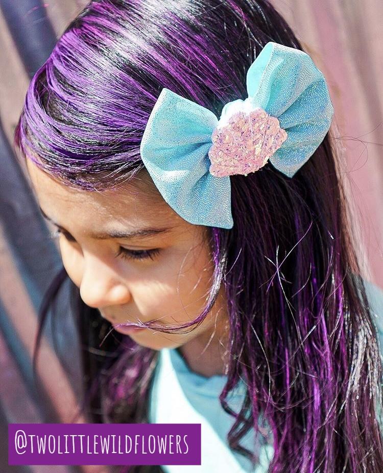 Young girl with purple hair colored using Hair Chalk, showing vibrant, easy-to-apply, non-toxic hair coloring for all ages.