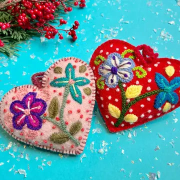 Embroidered Heart Ornament pair with colorful floral embroidery and textured french dots on red and pink wool hearts.
