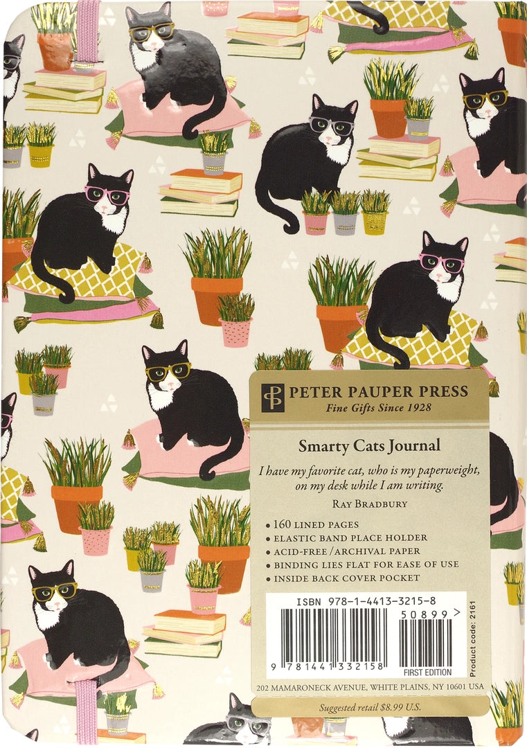 Journal cover with black and white cats on pillows among potted plants and stacked books with elastic closure