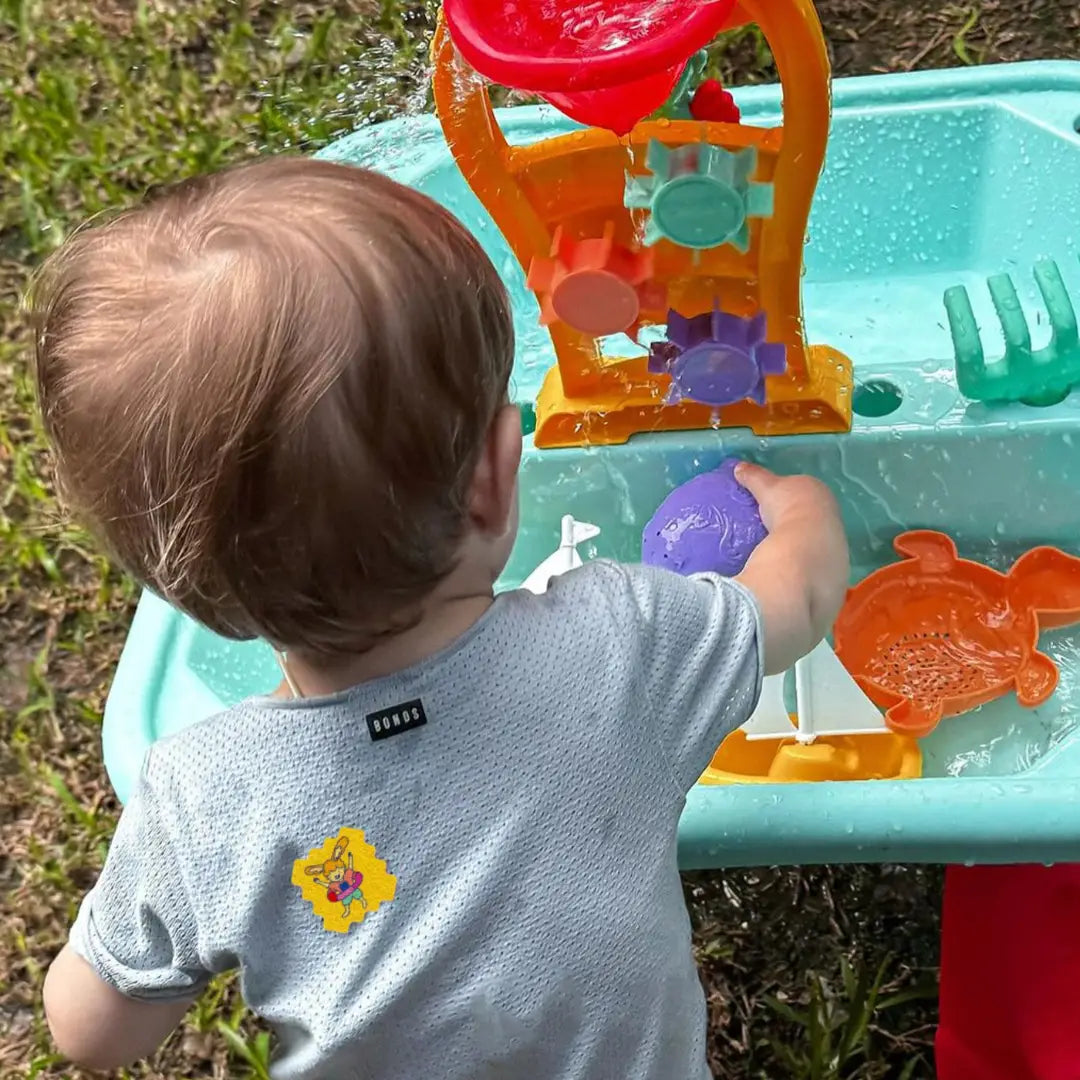 Child playing outdoors with Natpat | Trailpatch Tick Repellent Stickers on shirt for natural insect protection