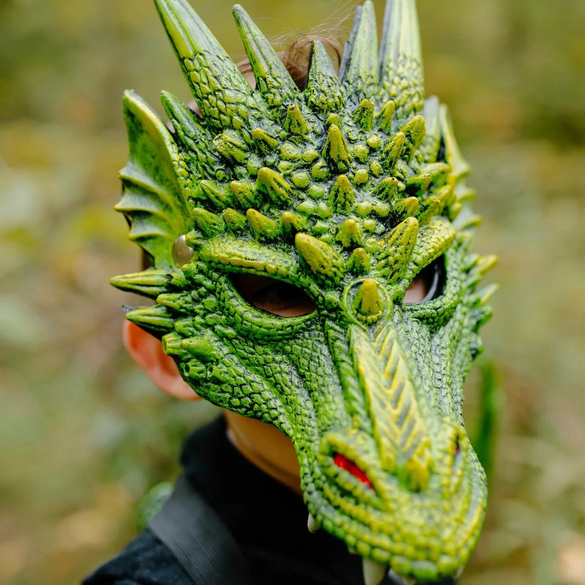 Dragon Mask | Green worn by child showing detailed rubberized foam texture and vibrant green scales outdoors.