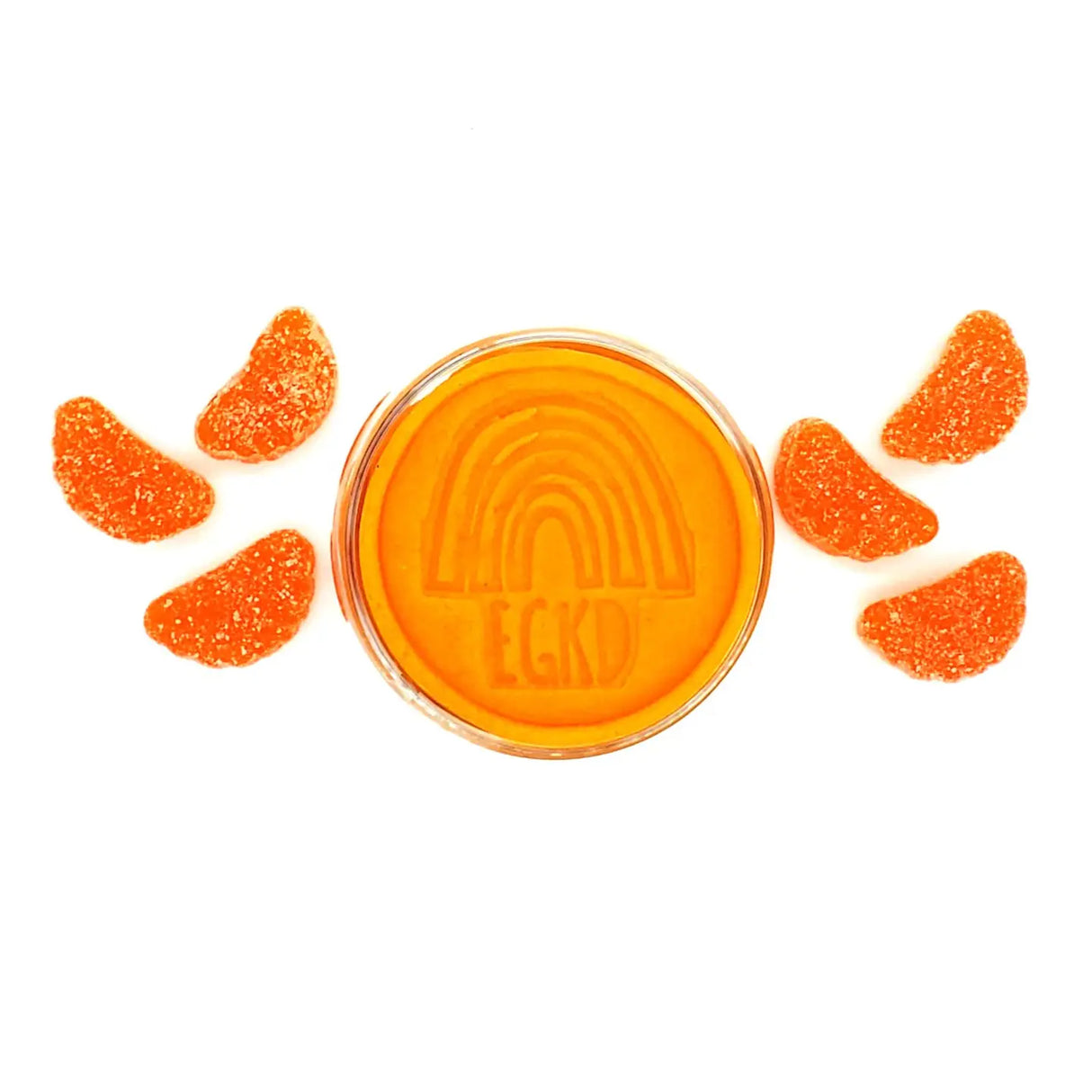 KidDough Glitter | Orange with bright orange dough and orange gummy slices arranged on white background.
