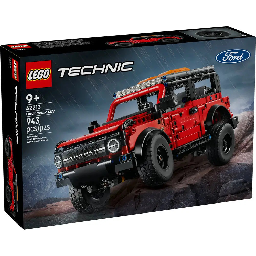 Red and black LEGO Technic Ford Bronco model with detailed features and off-road tires displayed on rocky terrain.