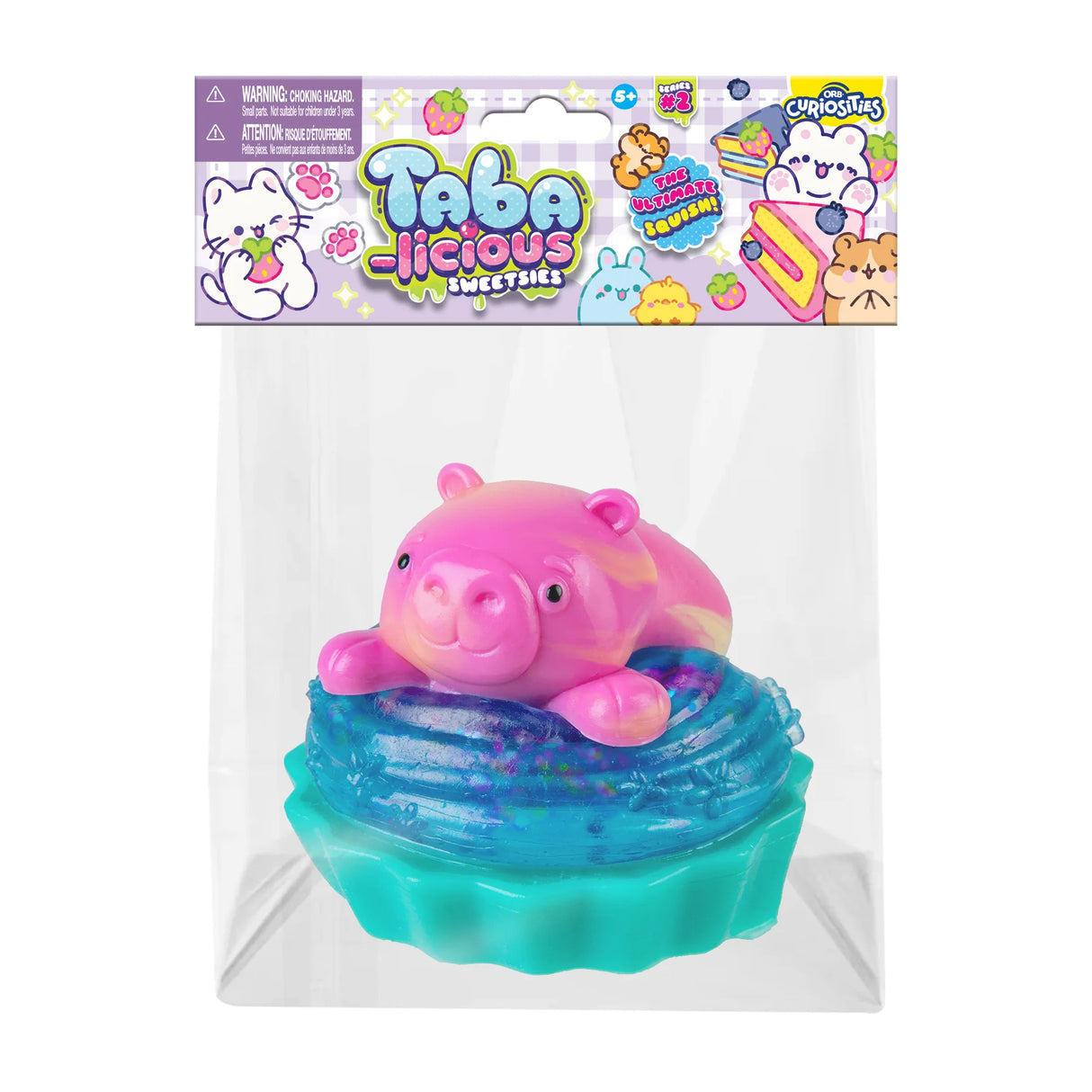 Taba-licious Sweetsies Squishy featuring a pink pig on blue frosting in clear packaging for collectible fun.