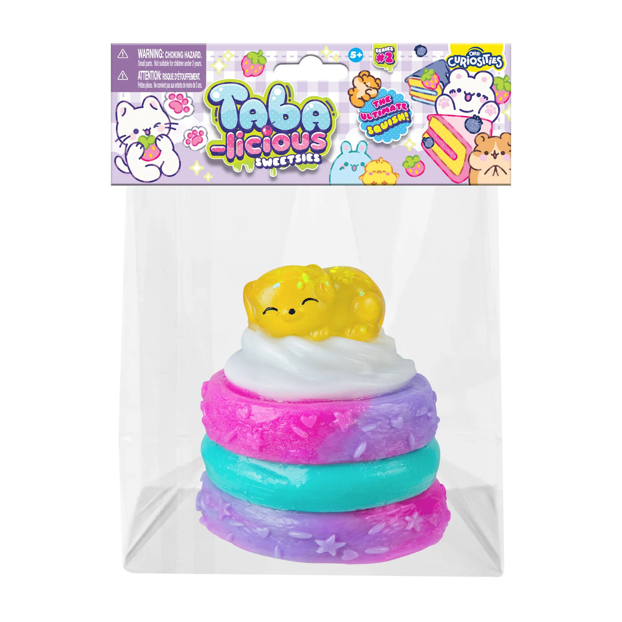 Taba-licious Sweetsies Squishy featuring a colorful, squishy dessert topped with a sleeping yellow animal figure.