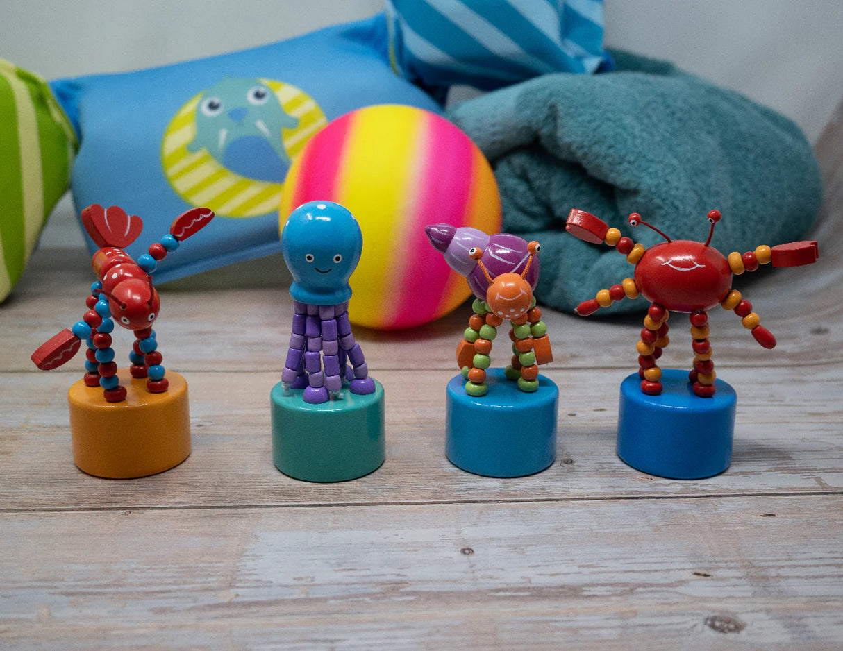 ThumbToy Ocean Creature colorful push puppets featuring lobster, octopus, starfish, and crab toys on a wooden surface.