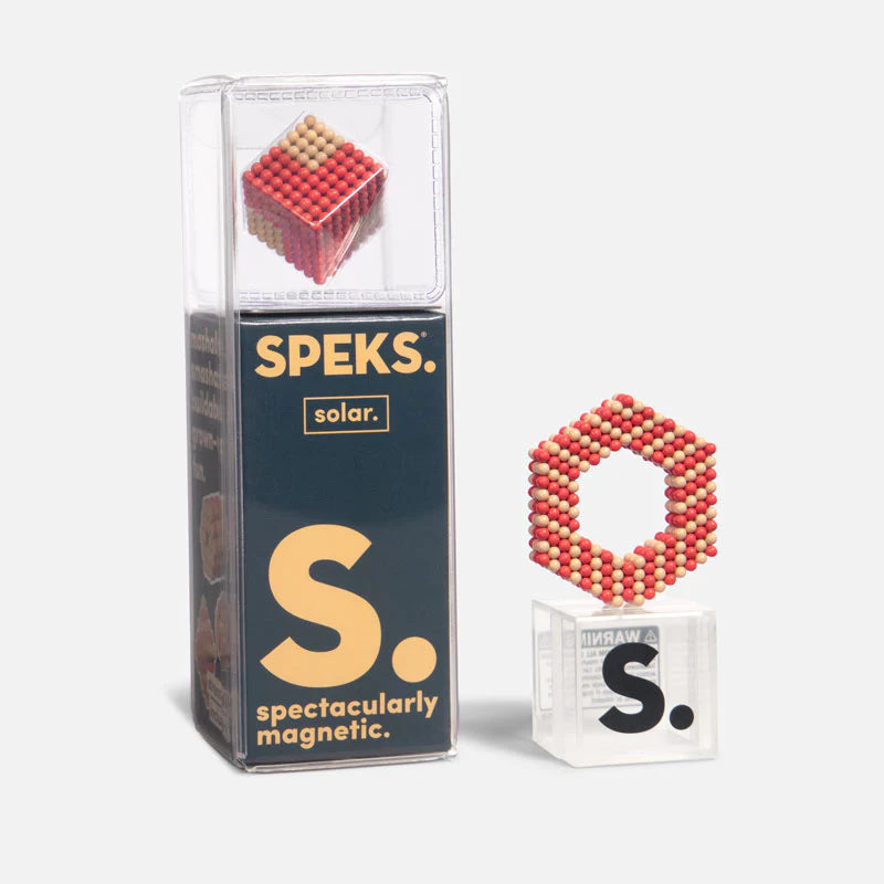 Speks Elements Solar magnetic balls in red and yellow forming a hexagon shape alongside its packaging.