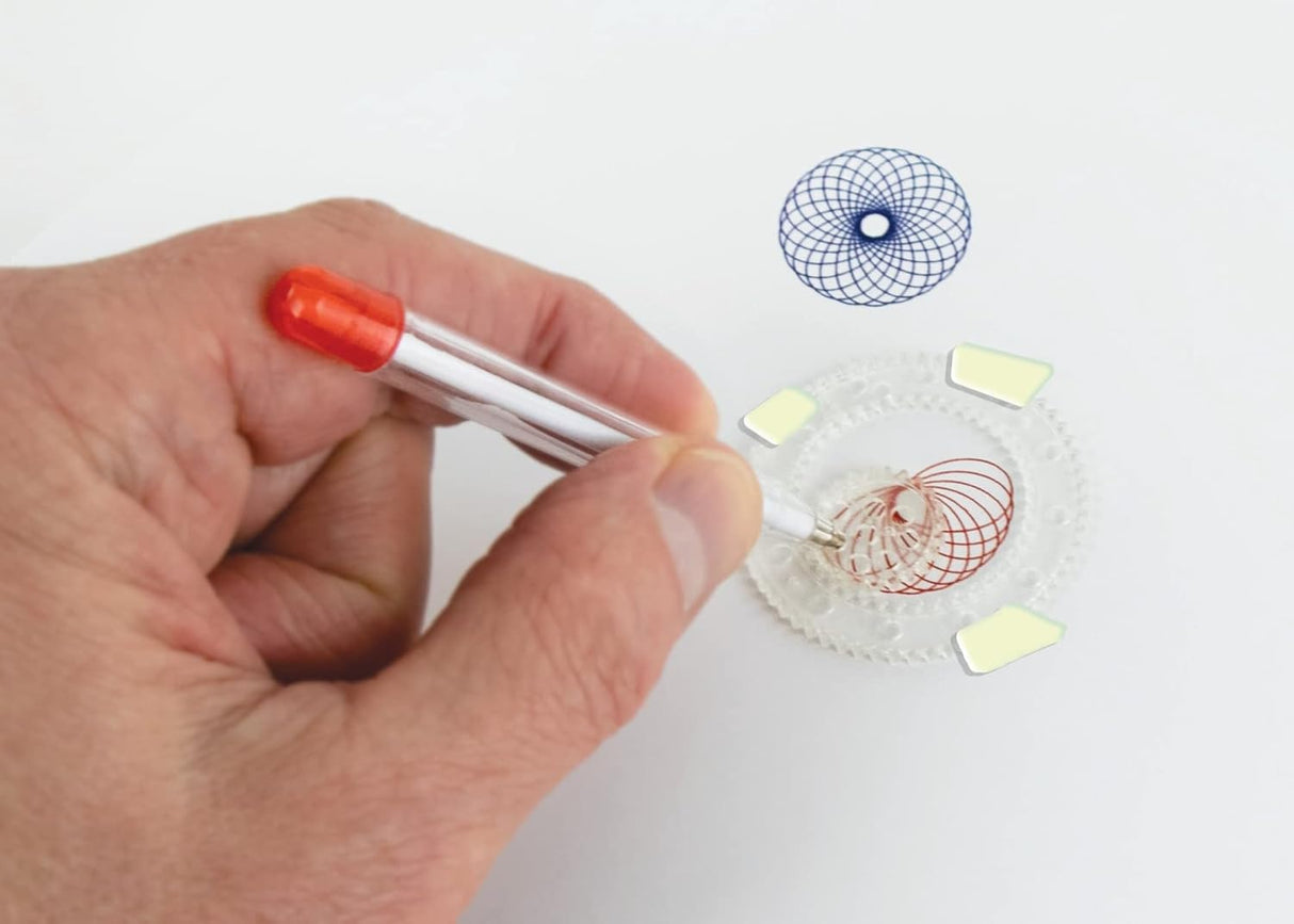 Hand using the world’s smallest spirograph to draw colorful geometric patterns on white paper