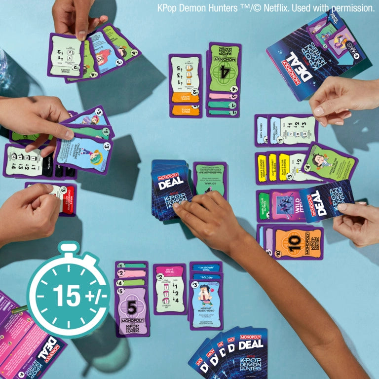 Monopoly Deal: Kpop Demon Hunters card game being played with colorful cards and a 15 minute game icon