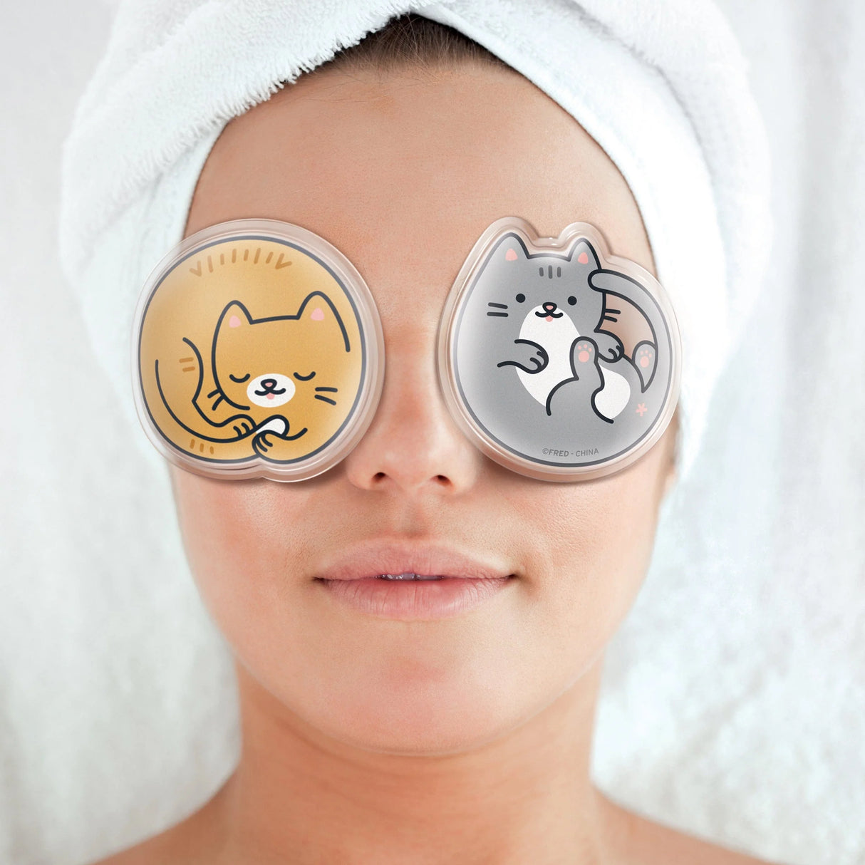 Woman relaxing with Chill Out! Eye Pads Kittens gel eye pads on closed eyelids for self-care.