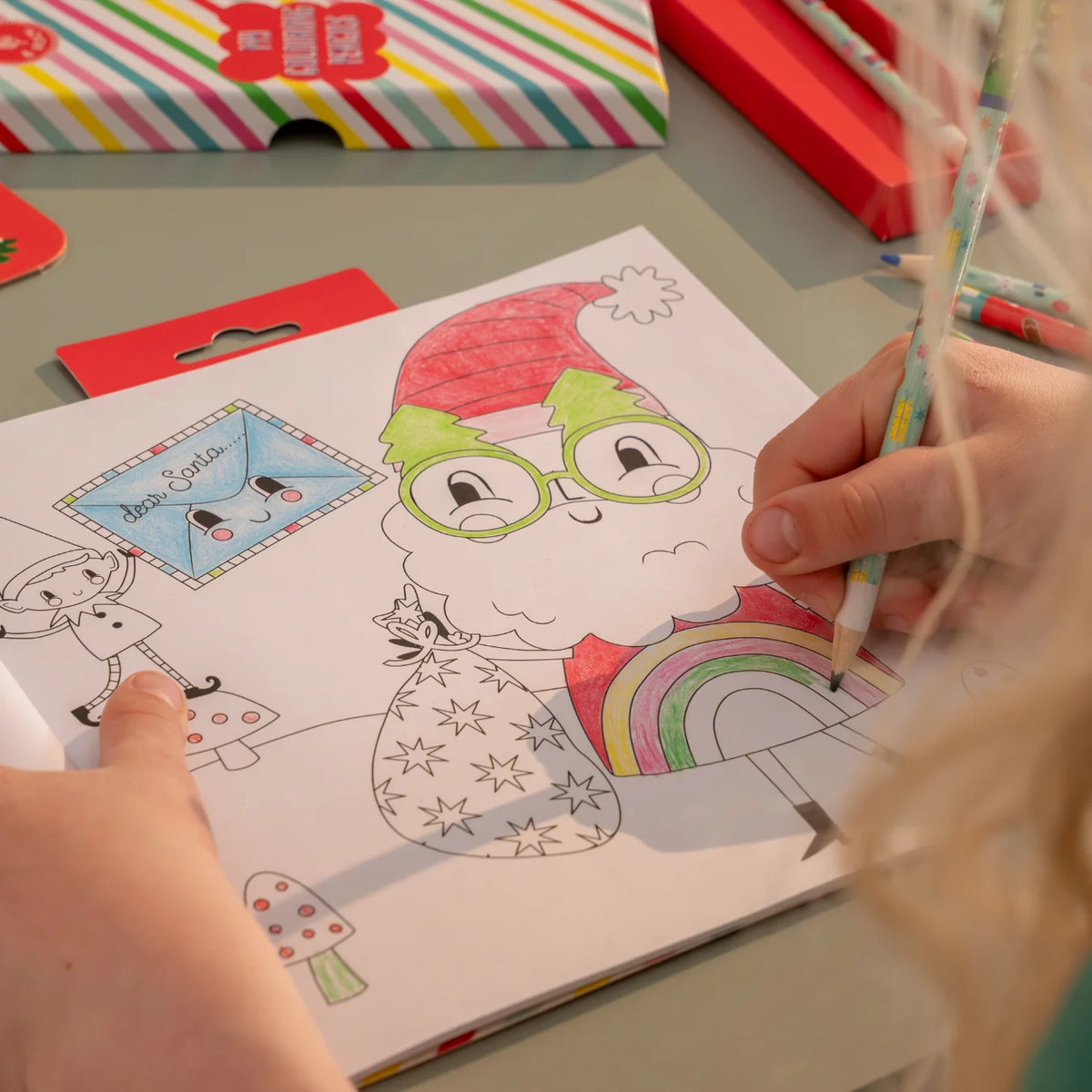 My Christmas Coloring Book & Stickers! with a child coloring a festive Santa illustration