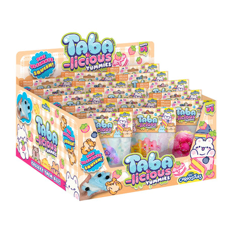 Display box of assorted Taba-licious Mega Yummies Squishy toys featuring colorful bakery-inspired designs.