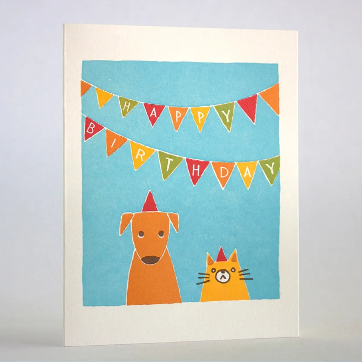Cat & Dog Birthday Card featuring a letter-pressed dog and cat with birthday hats under colorful banners.