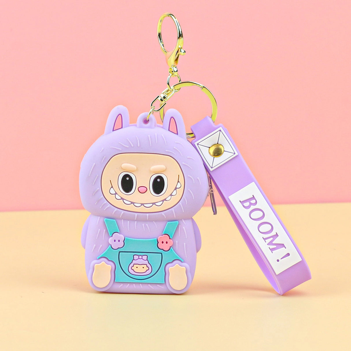 Labubu Cute Coin Purse in purple silicone with a smiling character design and attached keychain strap labeled BOOM.