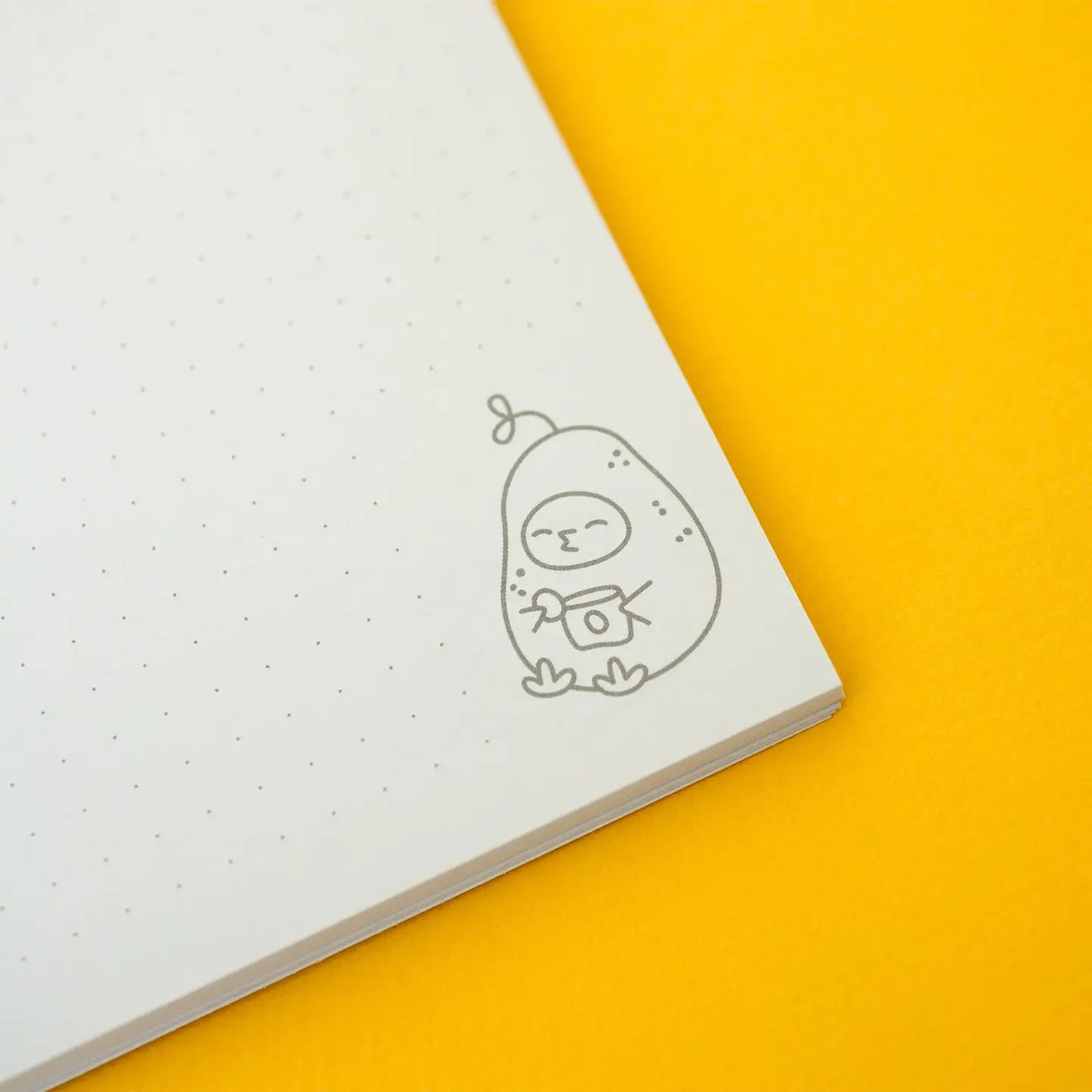 Open dotted page with small character illustration inside the Grumpy Chicken Potato Mode Notebook on yellow background.
