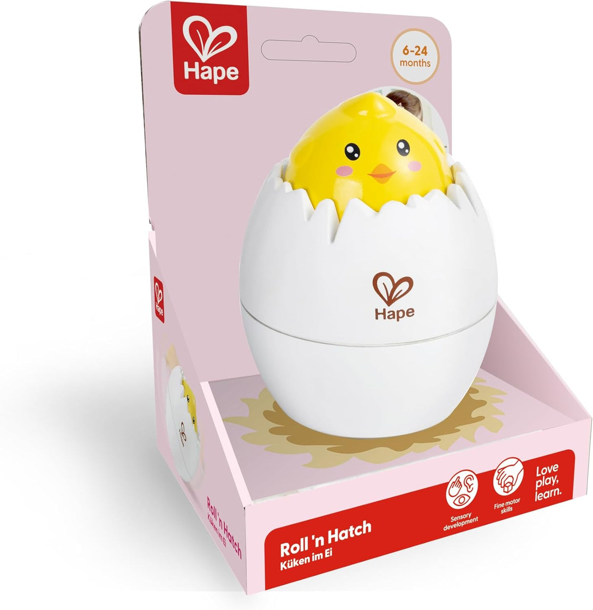 Yellow chick toy emerging from a white egg shell in colorful packaging for babies 6 to 24 months