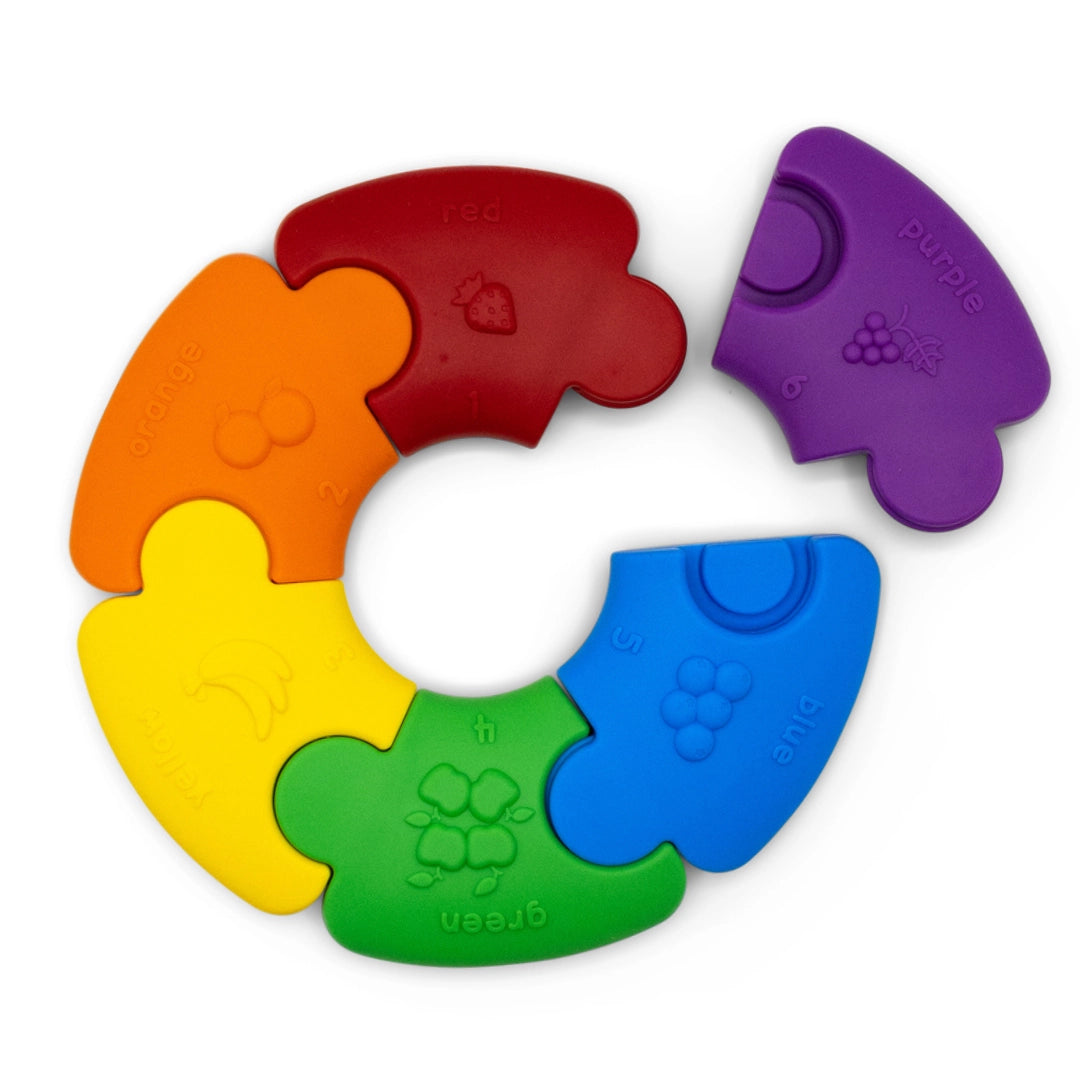 Color Wheel Puzzle pieces in bright colors with fruit shapes, designed for sensory and color recognition development for babies.