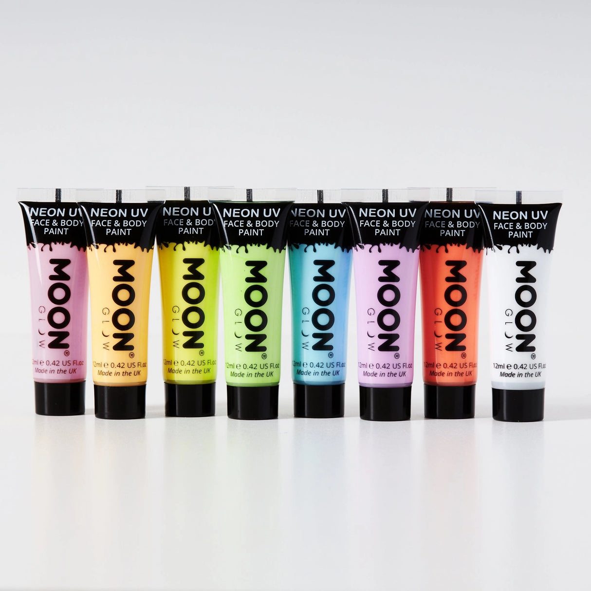 Face & Body Paints| Neon UV Glow showing eight vibrant neon colors in tubes arranged in a row on a white background
