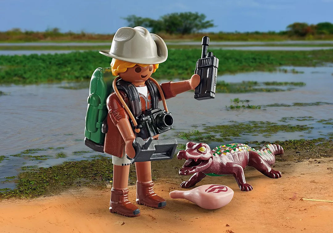 Special Plus | Researcher w/Alligator exploring a swampy area with equipment and a young alligator nearby.