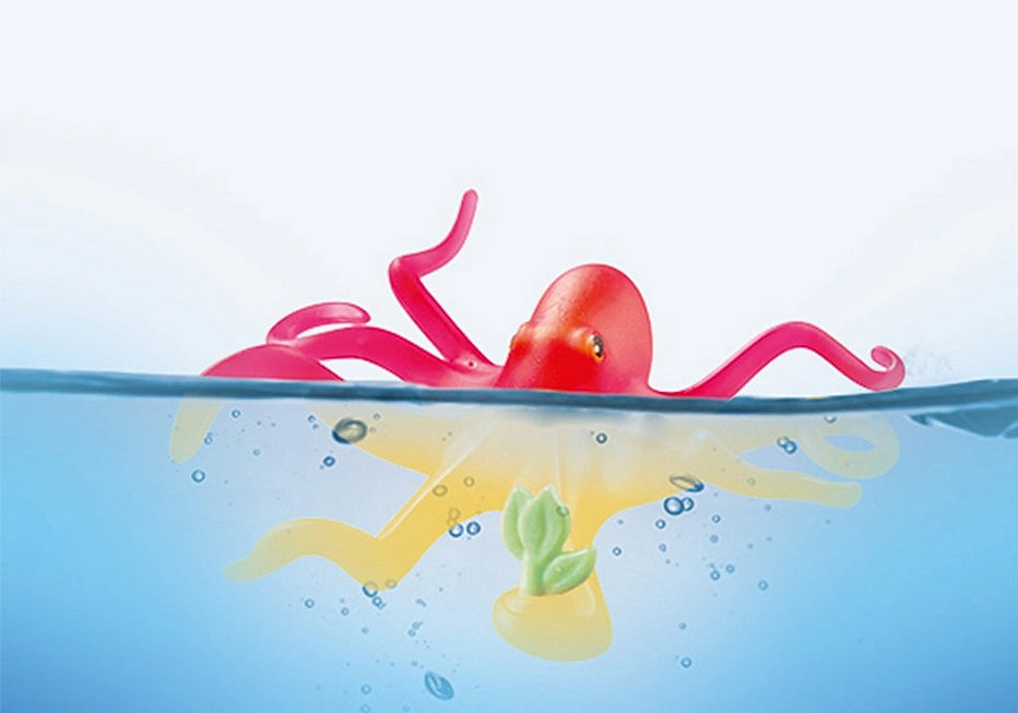 Princess Magic | Mermaid with Octopus toy showing color-changing octopus partially submerged in water with bubbles around.