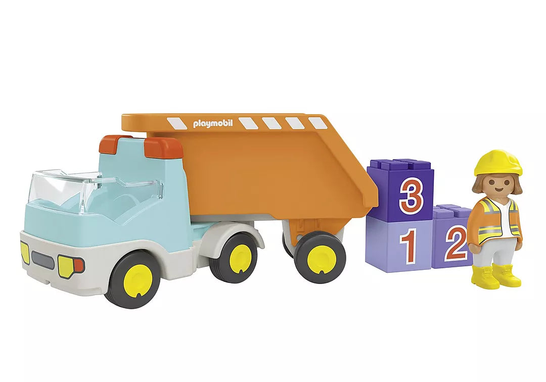 Junior Dump Truck toy with detachable orange dump bed, numbered stackable stones, and construction worker figure.
