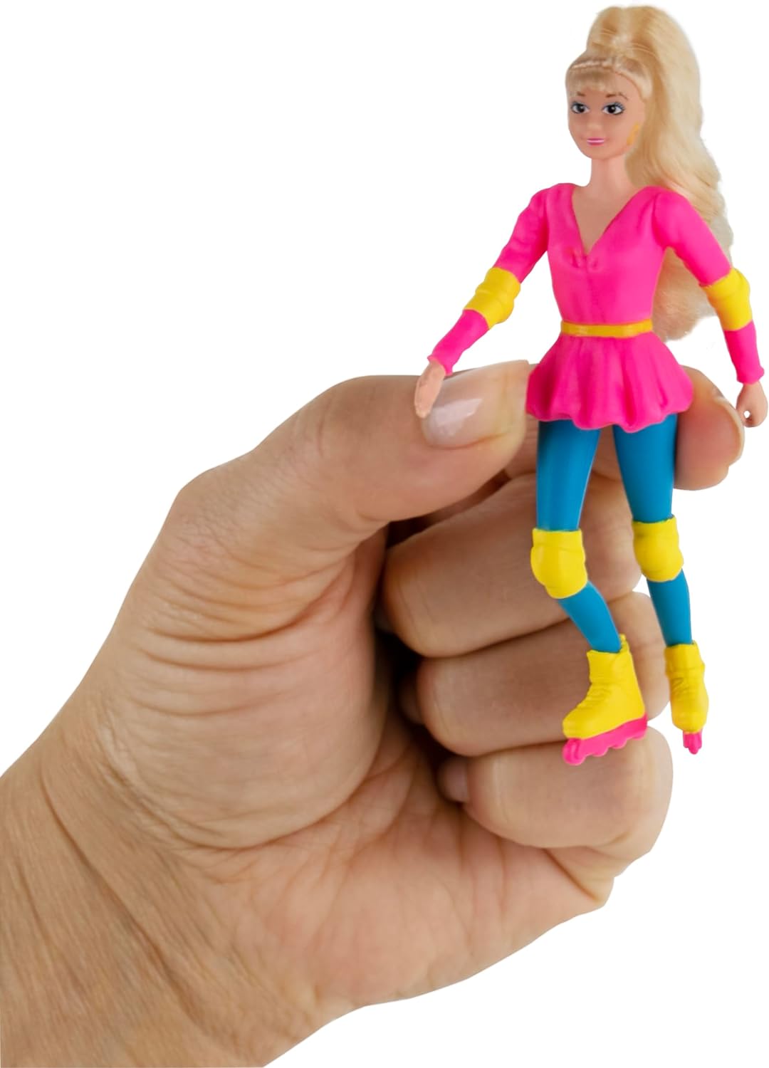 Hand holding World's Smallest Barbie dressed in rollerblade outfit with pink top and blue leggings.