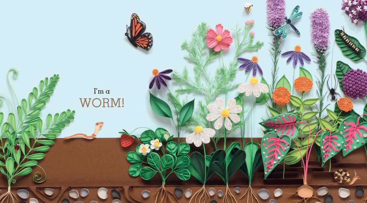 Just A Worm features a quilled garden scene with a worm, flowers, and insects celebrating nature’s interdependence.