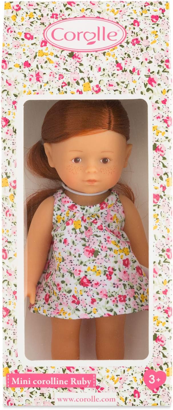 Mini Corolline Ruby doll with red hair, floral dress, and soft vinyl body in colorful Corolle packaging.