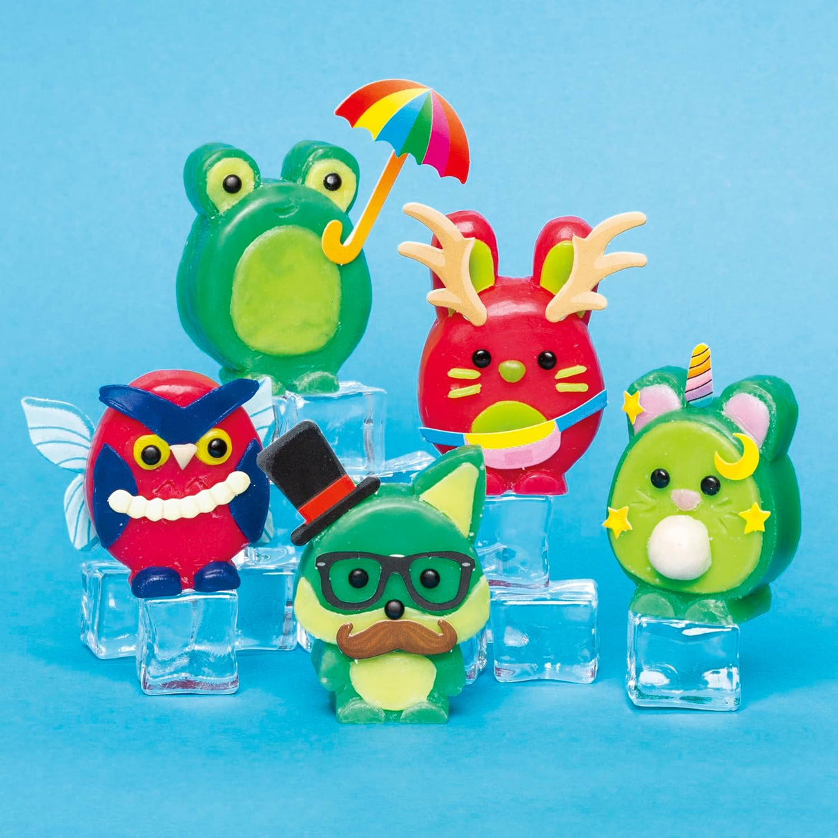 Easy to Carve Wax Animals featuring colorful frog, owl, cat, bunny, and mouse figurines on clear blocks.