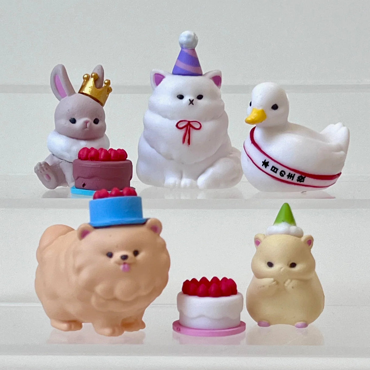Birthday Party Animals Blind Box with cute animal figurines wearing party hats and celebrating with cakes and gifts.