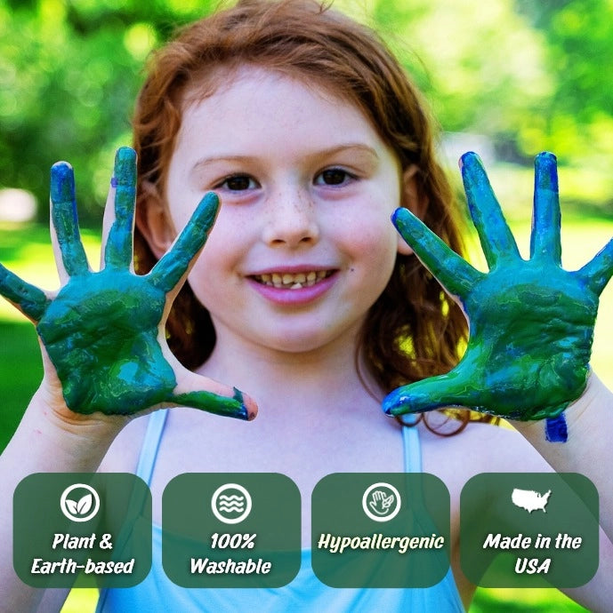 Child with painted hands outdoors showing Petite Natural Earth Paint Kit results, featuring washable, plant-based colors.