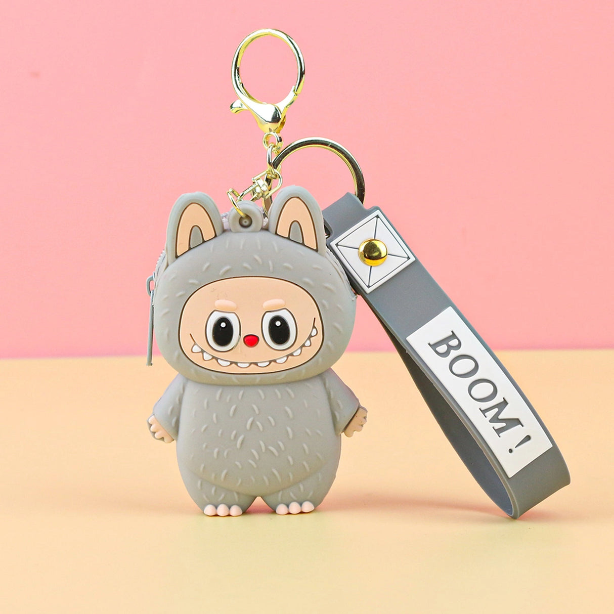 Labubu Cute Coin Purse in gray silicone with a playful character design and attached keychain strap on pink background.