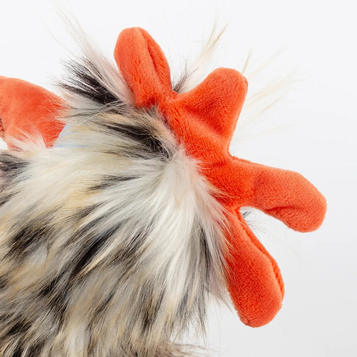 Close-up of plush rooster's orange comb and soft multicolored fur for Chicken Tour de Poule plush toy.