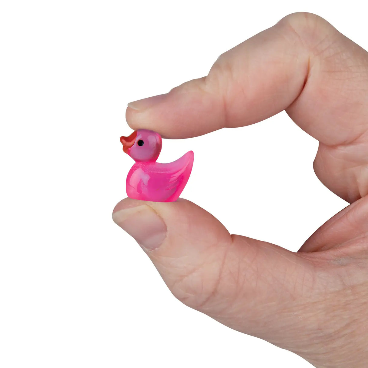 Hand holding a tiny pink duck toy, showcasing the small size of Teeny Tiny Ducks collectible resin figure.