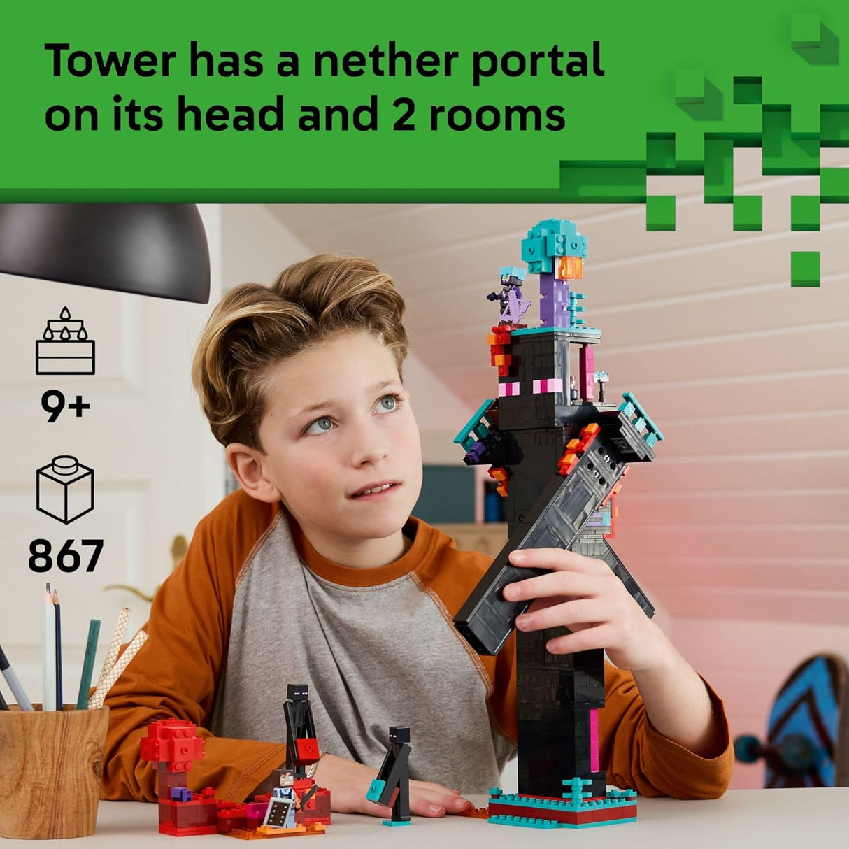 Child playing with a detailed Enderman Tower building set featuring a nether portal and multiple rooms for imaginative play.